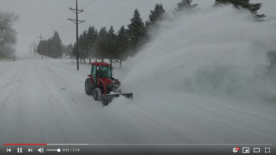 Clearing Snow with a Tractor Snowblower