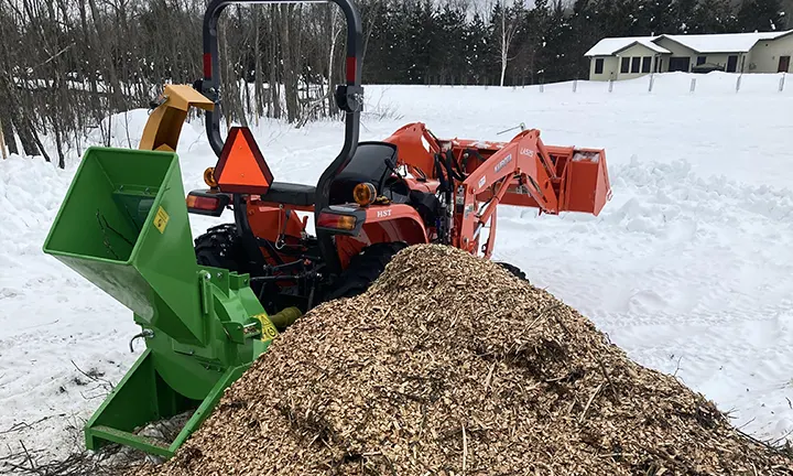 Victory Wood Chipper BX42S next to a pile of processed wood chips